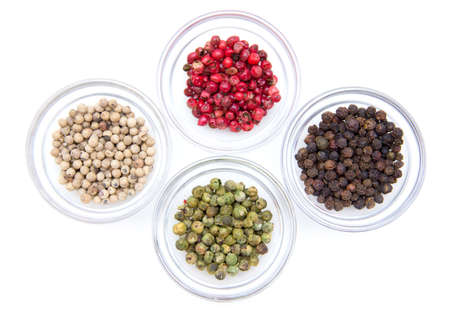 Bowls with mixed peppers on a white background seen from above