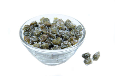 Salted capers in bowl on white backgroundの写真素材