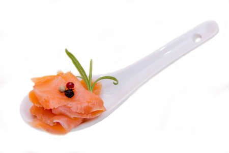 Teaspoon of smoked salmon on white backgroundの写真素材