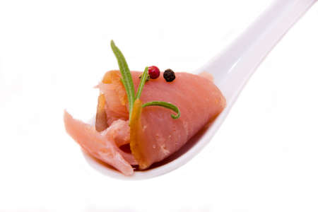 Teaspoon of smoked tuna on a white background seen closeの写真素材