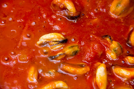 Mussels and sauce seen from up close while cookingの写真素材