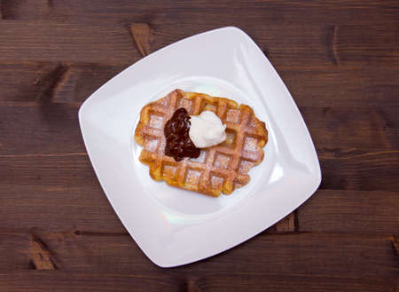 waffles with chocolate cream on wooden table seen from aboveの写真素材