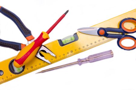 Working tools scattered on a white background seen from above