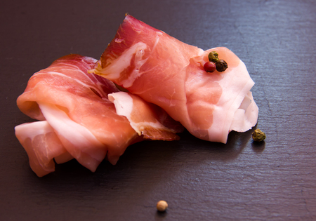 Slices of bacon on top slate seen up closeの写真素材