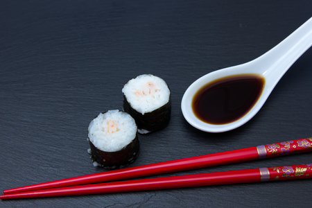 Maki with shrimp on a slate floor seen up closeの写真素材