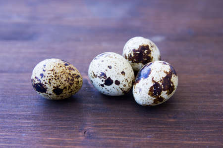 Some quail eggs on a wooden table