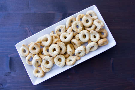 Bagels on a ceramic tray on a wooden table seen from aboveの写真素材