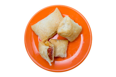 Puff pastry appetizers with salami and cheese on a white background seen from aboveの写真素材