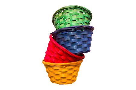 Colored wicker baskets one inside the other on a white backgroundの写真素材