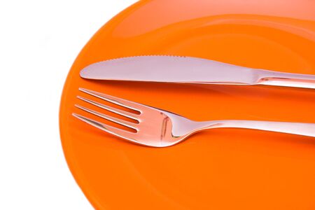 Plate with cutlery on a white background seen up closeの写真素材