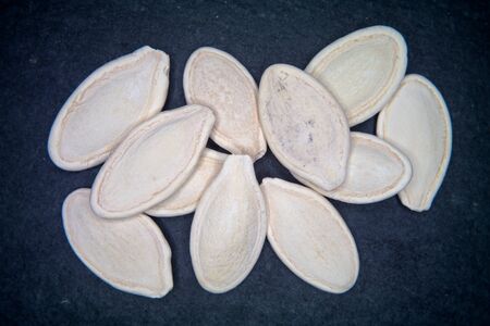 Pumpkin seeds on a slate floor seen from aboveの写真素材