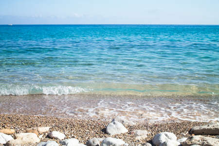 Waves on the seashore with the horizon in the background