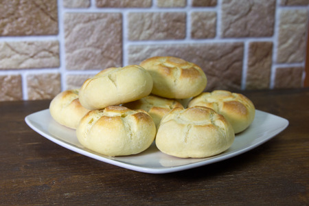 Bread on a plate on a wooden table