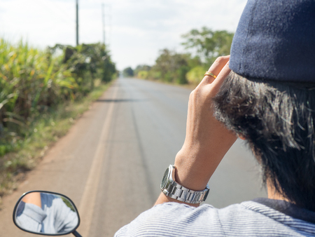 Women riding motorcycle no wear helmet on countrysideの写真素材