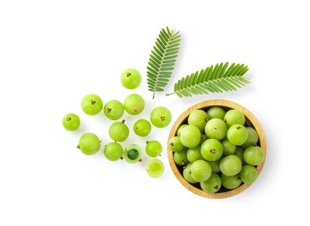 Indian gooseberry and leaf in wood bowl on white background. top viewの写真素材