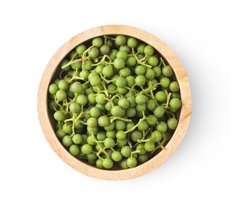 fresh Szetchwan pepper in wood bowl on white background. top viewの写真素材