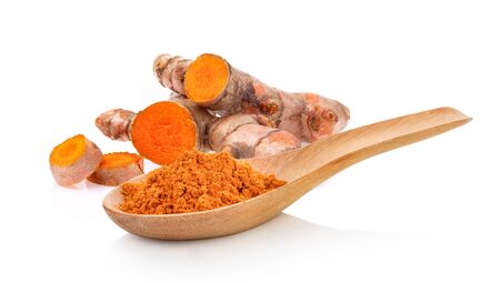 Turmeric powder in wood spoon isolated on white background. full depth of fieldの写真素材