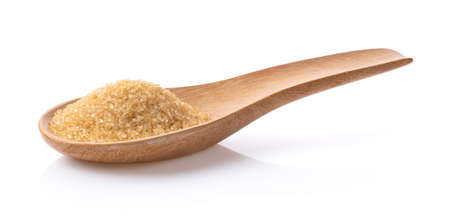brown sugar in wood spoon isolated on white backgroundの写真素材