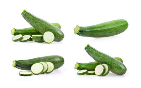 fresh green zucchini with slice isolated on white backgroundの写真素材