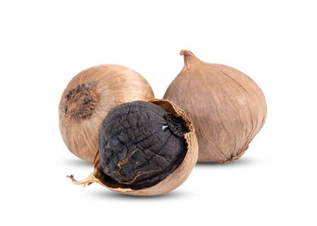 Black garlic bulbs isolated on white backgroundの写真素材
