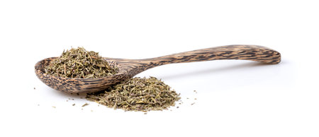 Heap of dried Thyme in wood spoon isolated on white background