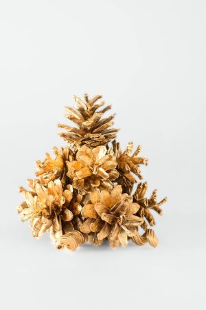 Christmas tree of the golden cones on a white backgroundの写真素材