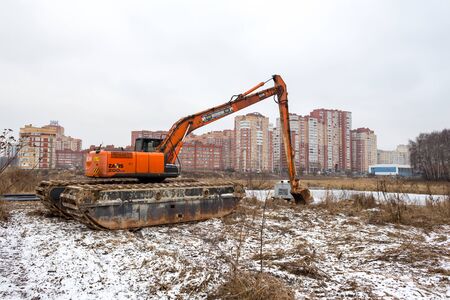 Balashikha, Moscow region, Russia - November 29, 2017: Transportation of a floating excavator to the bank of the river Pekhorka for cleaning the riverbedのeditorial素材