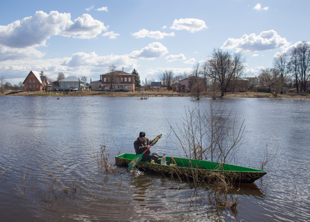 Kholuy, Ivanovo Region, Russia - April 27, 2018: Revival of the old tradition, the artistic painting of boats and their descent into the water during the spring flood of the Teza Riverのeditorial素材