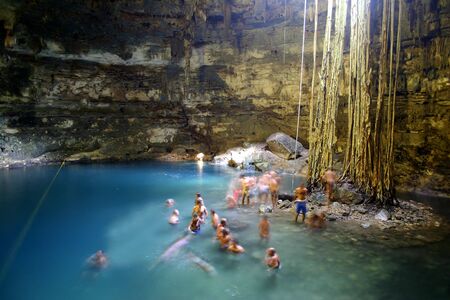 People bathing in limestone cave lake in Yucatan, Mexicoの写真素材