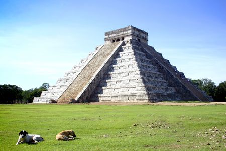 Main pyramid of Chitchen Itza site in Yucatan, Mexico with local dogs in foreground.