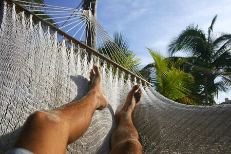 Legs and hammock in tropical surroundingsの写真素材