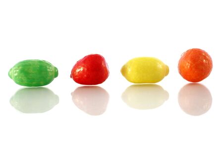 Fruit-shaped candy in a row with reflectionsの写真素材