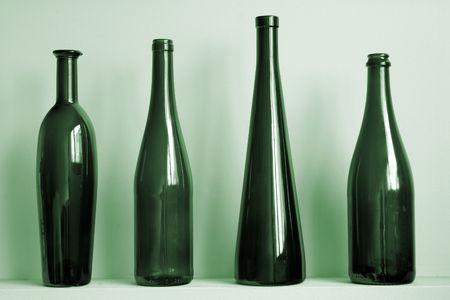 Green bottles against a wallの写真素材
