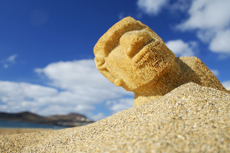 Easter Island Moai half buried in the sandの写真素材