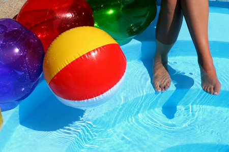 Beach ball and women's legsの写真素材