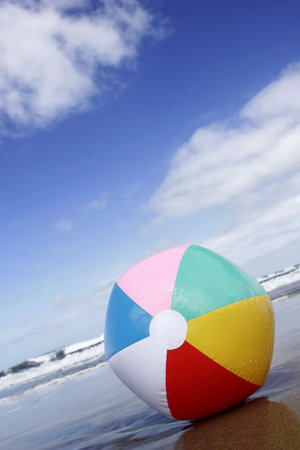 Bright multicolored beach ball on the beachの写真素材