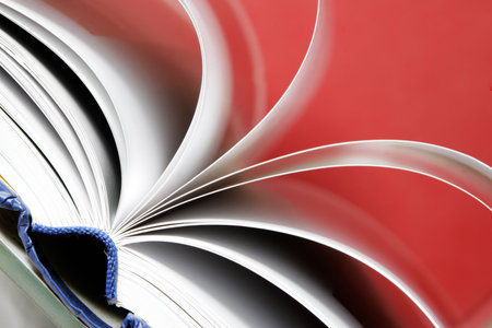 Book with white pages open against a red backgroundの写真素材