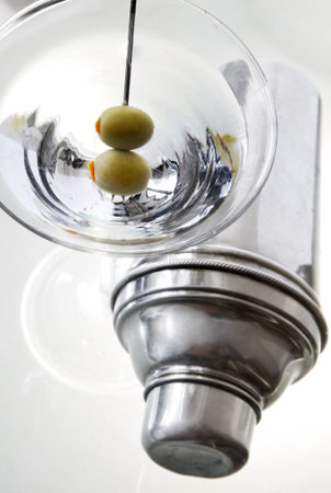 Two olive classic martini with shaker and uplit barの写真素材