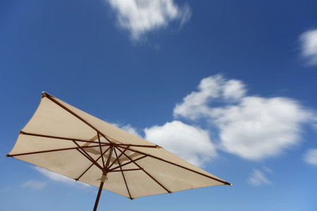 White Parasol with blue sky and clouds の写真素材