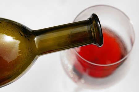Wine pouring from bottle from aboveの写真素材