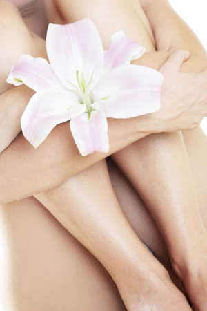 Woman with a pink lily flowerの写真素材