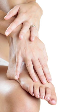 Woman's hands and foot over whiteの写真素材