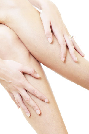 Woman massaging her legsの写真素材