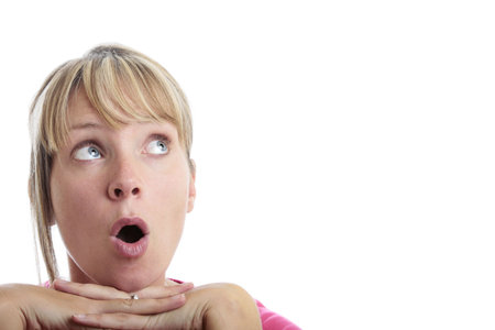 Surprised woman looking up with white backgroundの写真素材