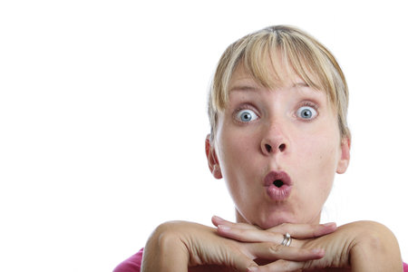 Surprised woman looking up with white backgroundの写真素材