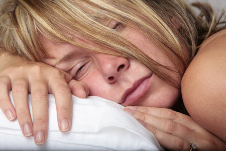 Blond woman waking up in the morningの写真素材