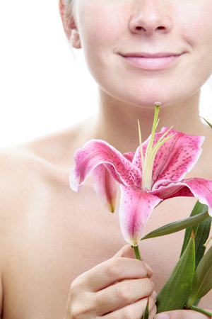 Woman and pink lily flower with white background.Focus is on the flower.の写真素材