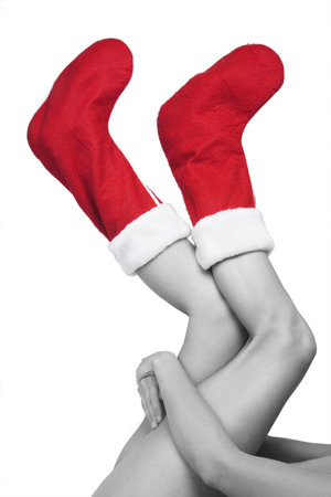 Woman with red christmas stockings on her feetの写真素材