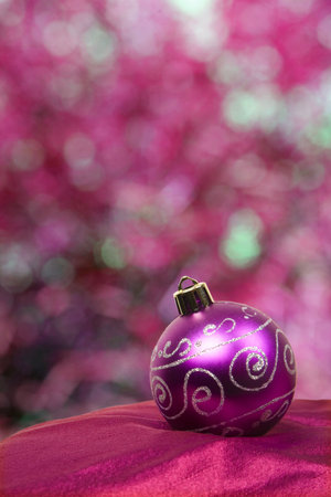 A nice purple bauble in front of a lovely defocused backgroundの写真素材