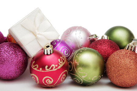 Mixed Christmas Baubles with a white gift box and white backgroundの写真素材